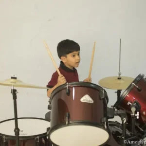 kid playing drum at Music academy
